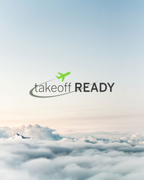 Image of a snow-covered mountain peeking over white clouds with light blue skies with the Takeoff Ready logo