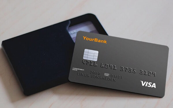 Image of a generic dark grey credit card resting on a black card holder