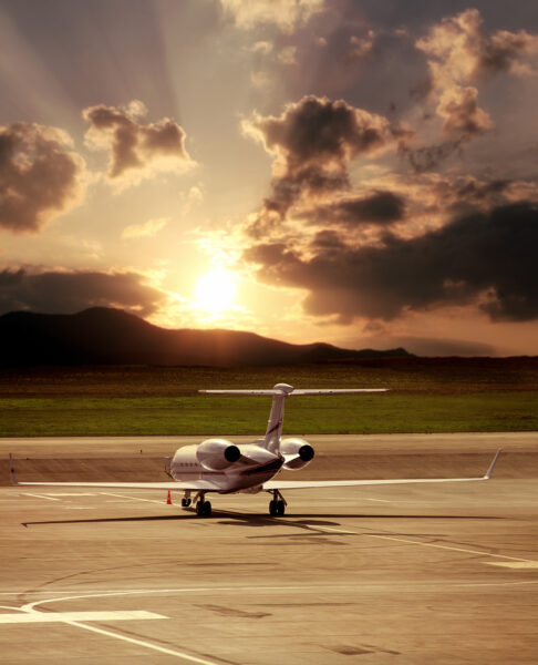 Business jet on the tarmac at sunset