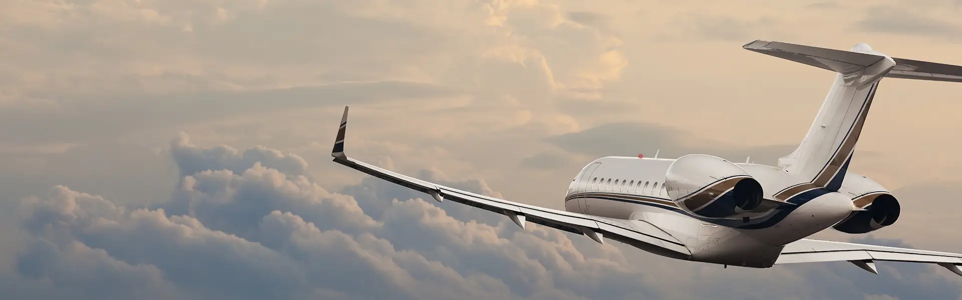 A private jet soaring above the clouds, rear-view.