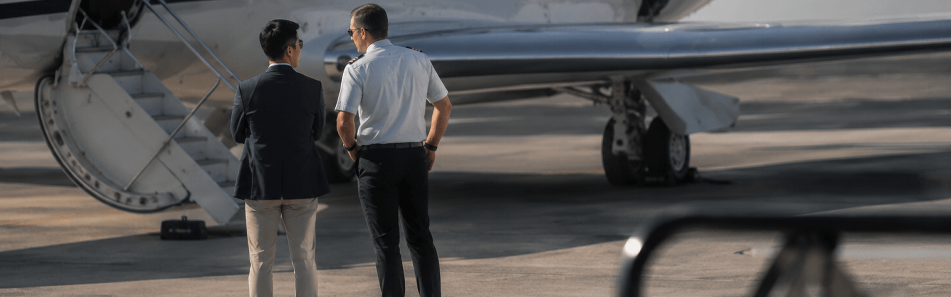 business-men-and-pilot-in-front-of-aircraft