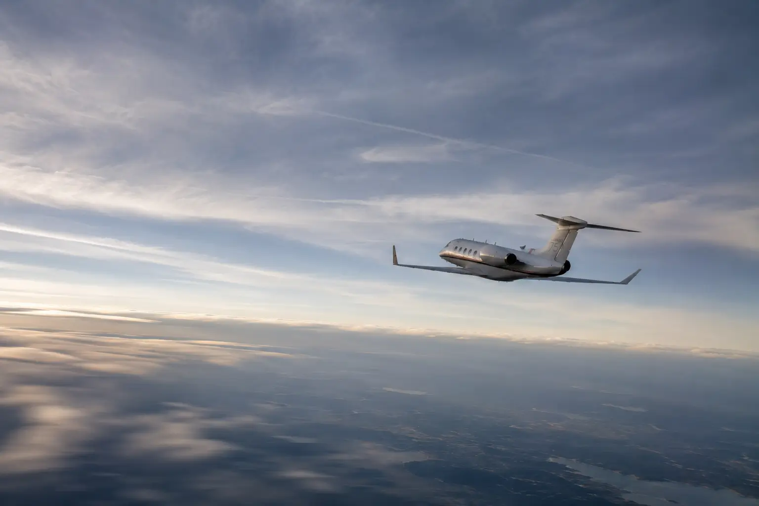 Image of a plane flying away in a cloudy sky.