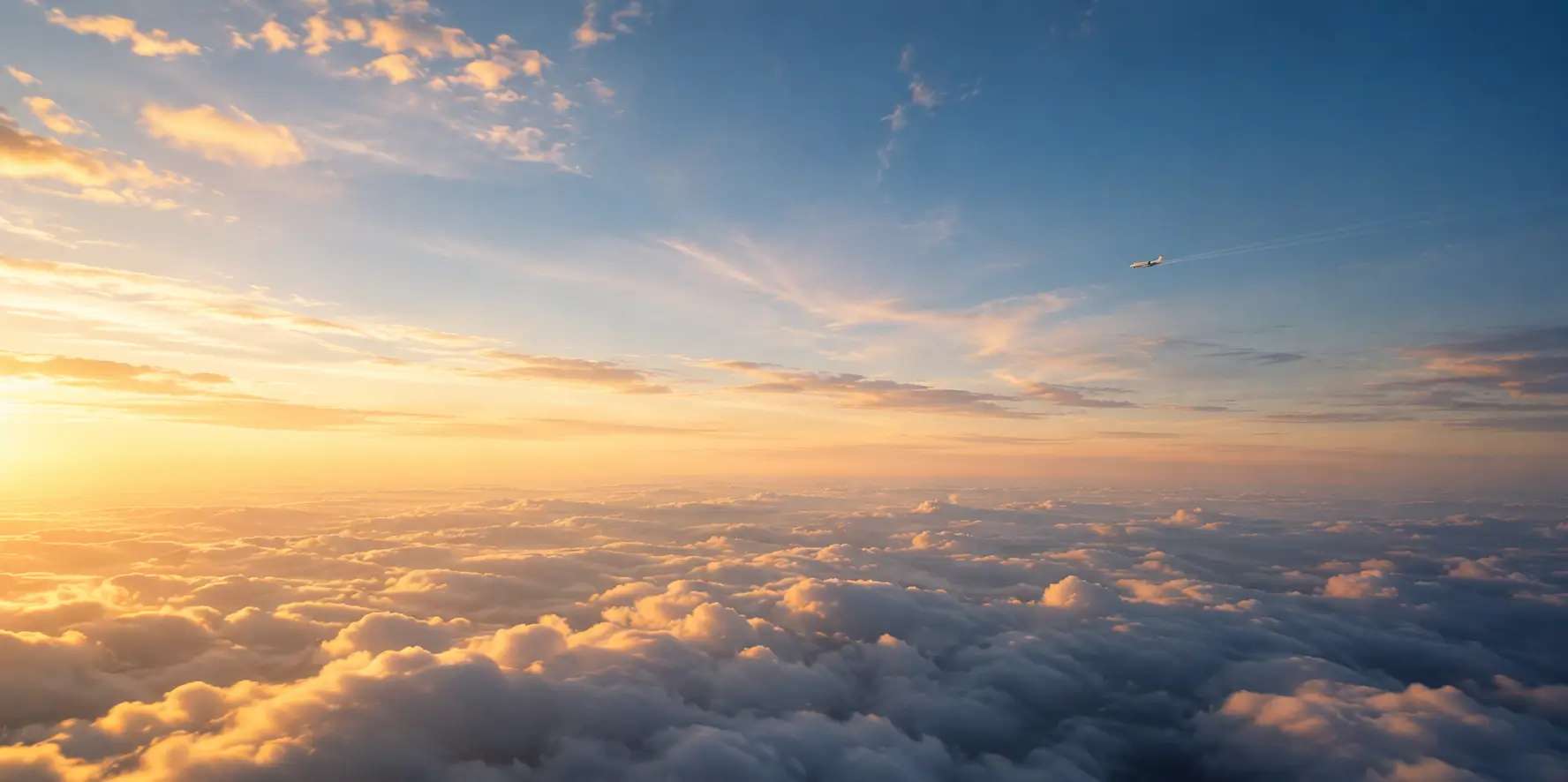 Hero image of a sunset above the clouds with an aircraft flying in the distance.